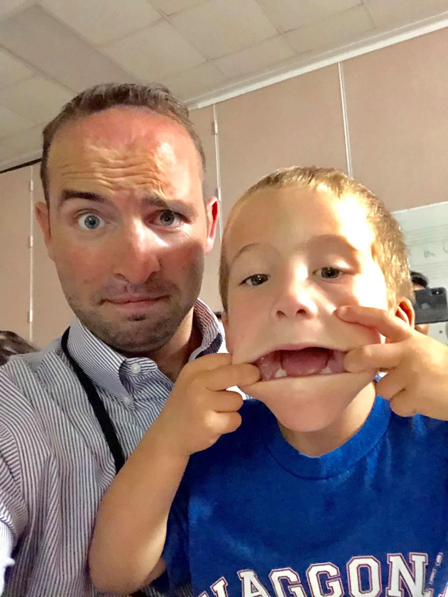 Kevin taking a fun selfie with a student